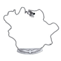 Freebird Necklace featuring a solid brass pendant etched with an eagle design on an adjustable cable chain.
