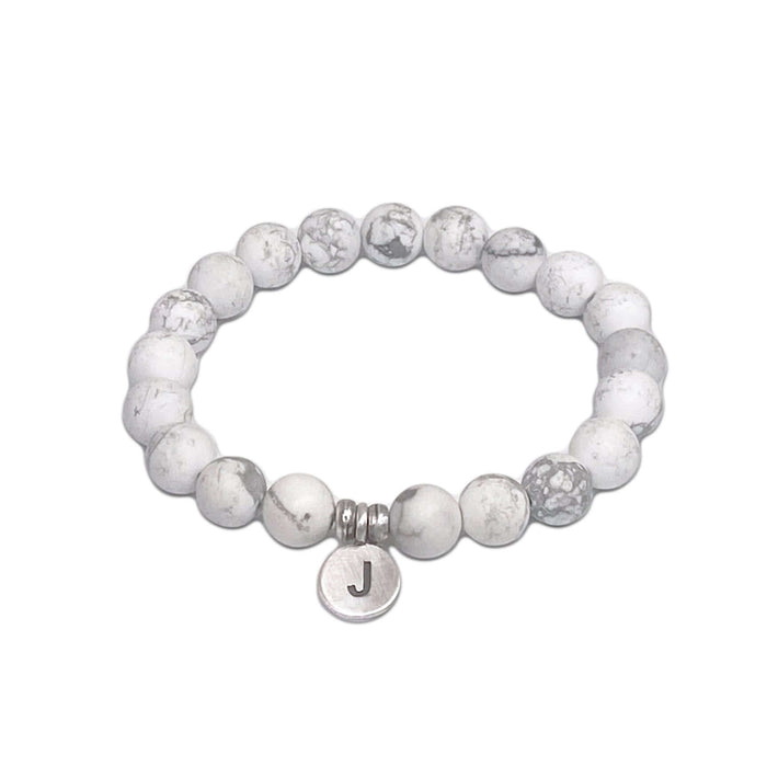 Initial Stretch Bracelet Collection featuring a personalized white Howlite bracelet with initial J disk.