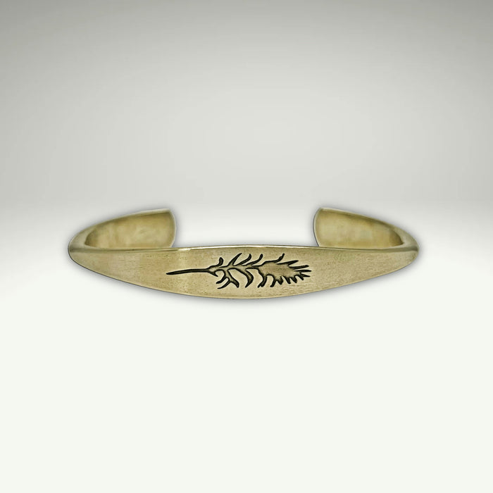 a gold bracelet with a design on it