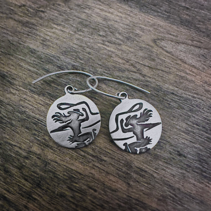 Disc earrings with a cowgirl on her horse with a lasso 