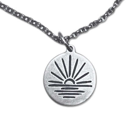 Sunrise Necklace with a silver pendant depicting a sunrise over water on an adjustable rolo chain.