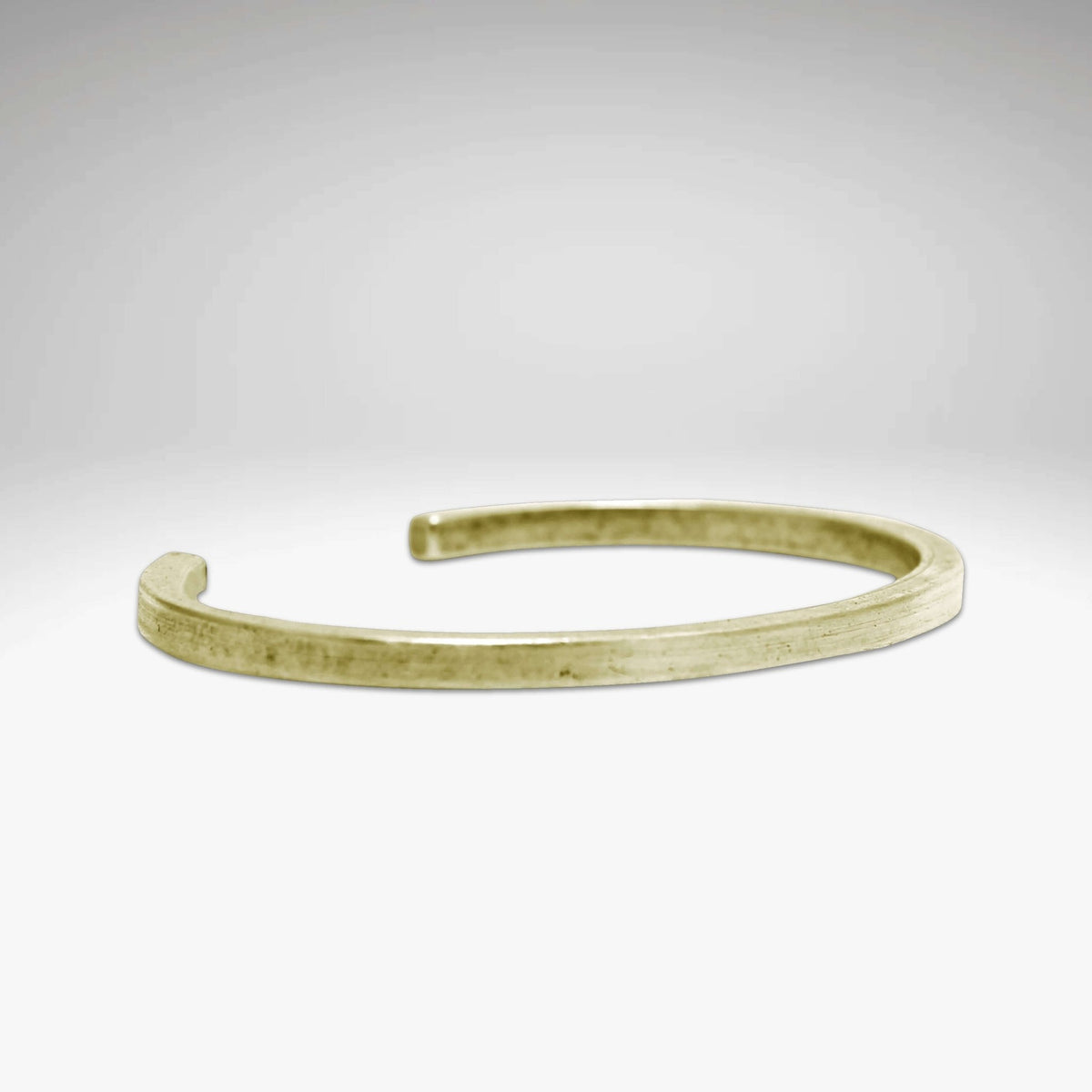 All Square Cuff Bracelet in Antique Brass finish on a soft gradient background.