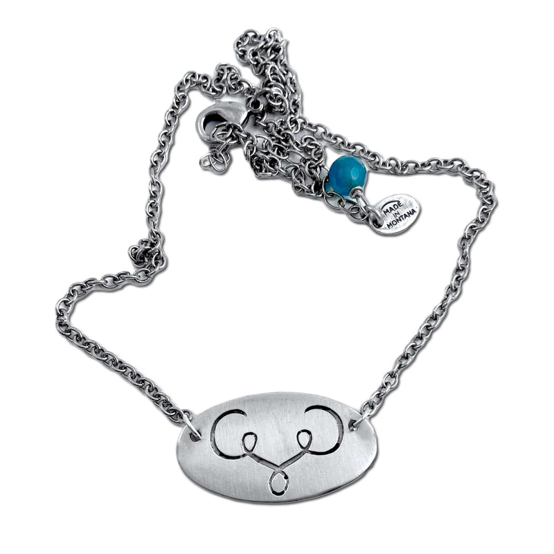 Ancient Buff Necklace on a silver chain with an adjustable clasp and decorative bead.