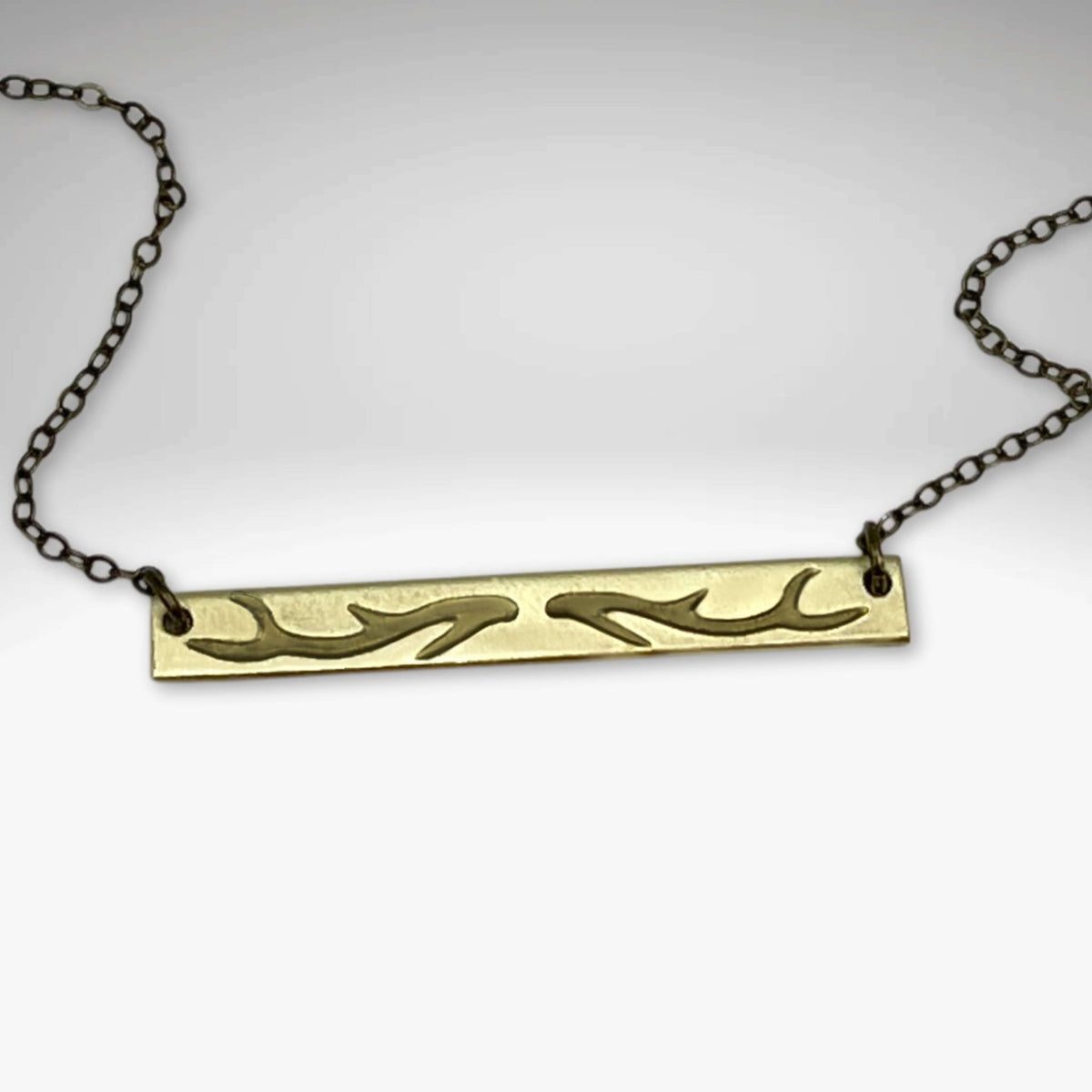 Antler Bar Necklace showcasing its unique design and adjustable chain, symbolizing love for nature's beauty.