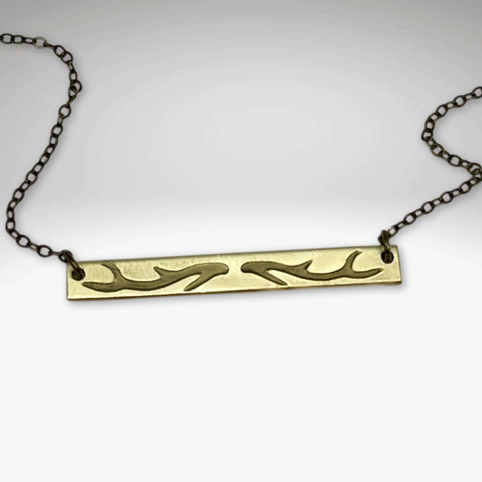Antler Bar Necklace showcasing its unique design and adjustable chain, symbolizing love for nature's beauty.