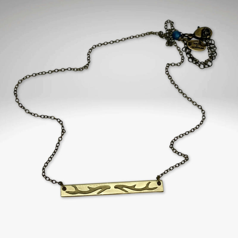 Antler Bar Necklace showcased on a cable chain with adjustable length, highlighting its unique acid-free etching finish.