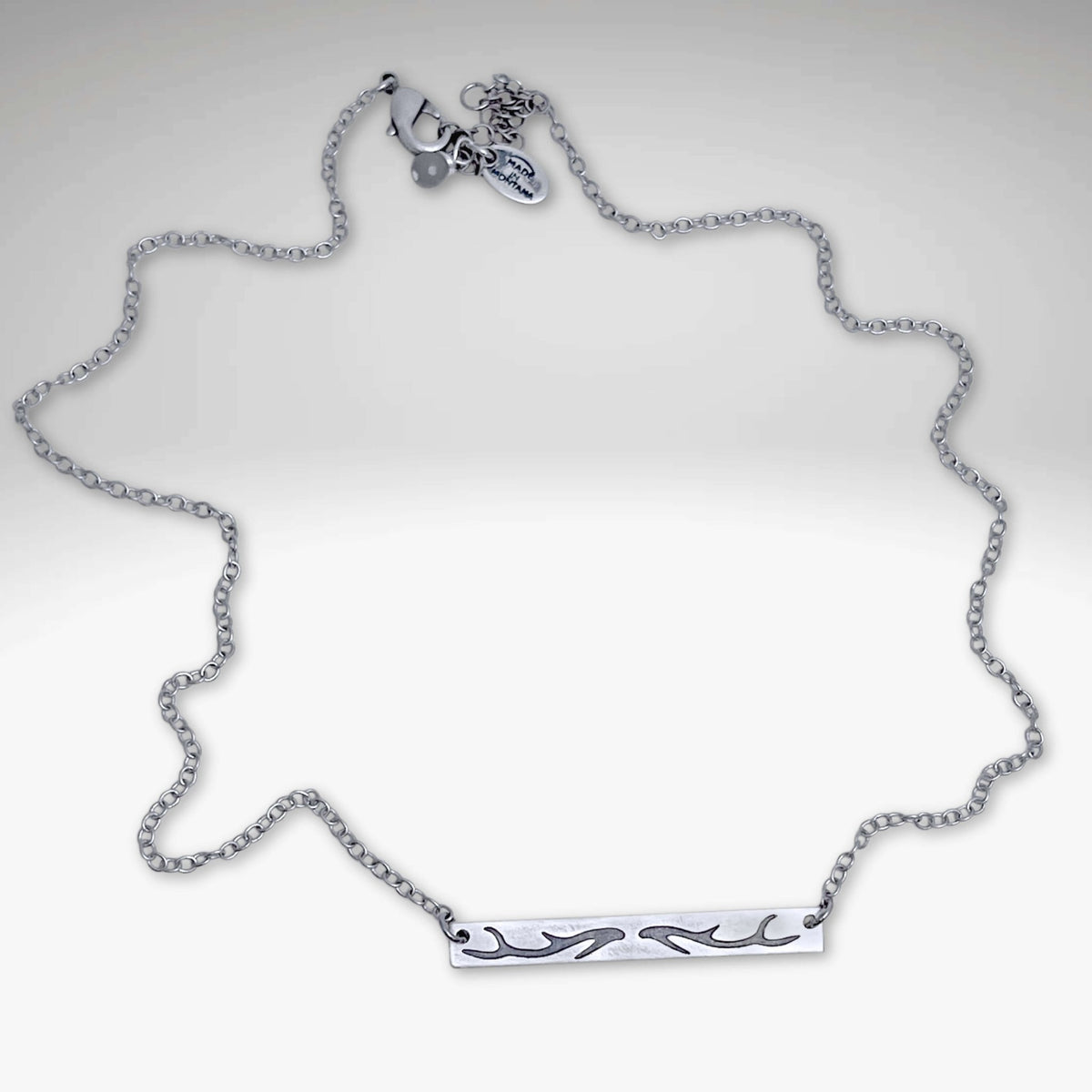 Antler Bar Necklace in matte silver with a delicate cable chain, showcasing nature-inspired design.