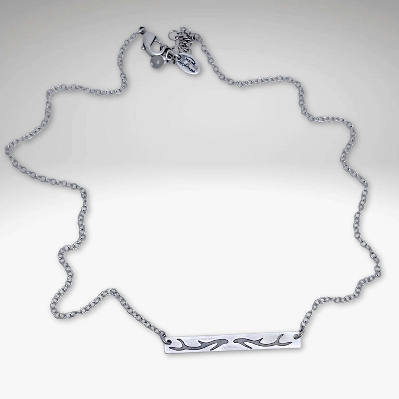 Antler Bar Necklace in matte silver with a delicate cable chain, showcasing nature-inspired design.