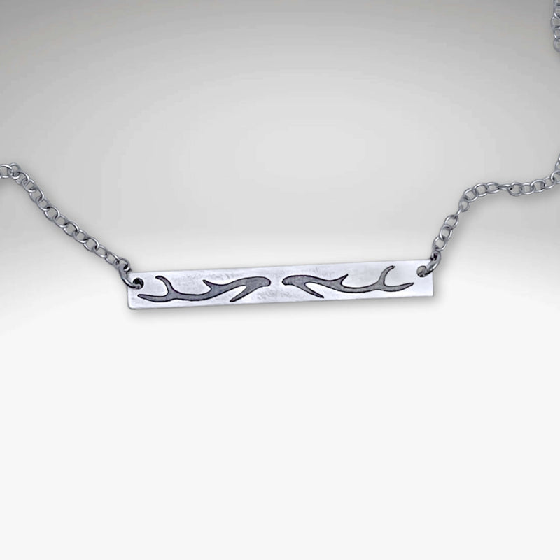 Antler Bar Necklace showcasing a unique etching design, adjustable cable chain, in Matte Silver finish.