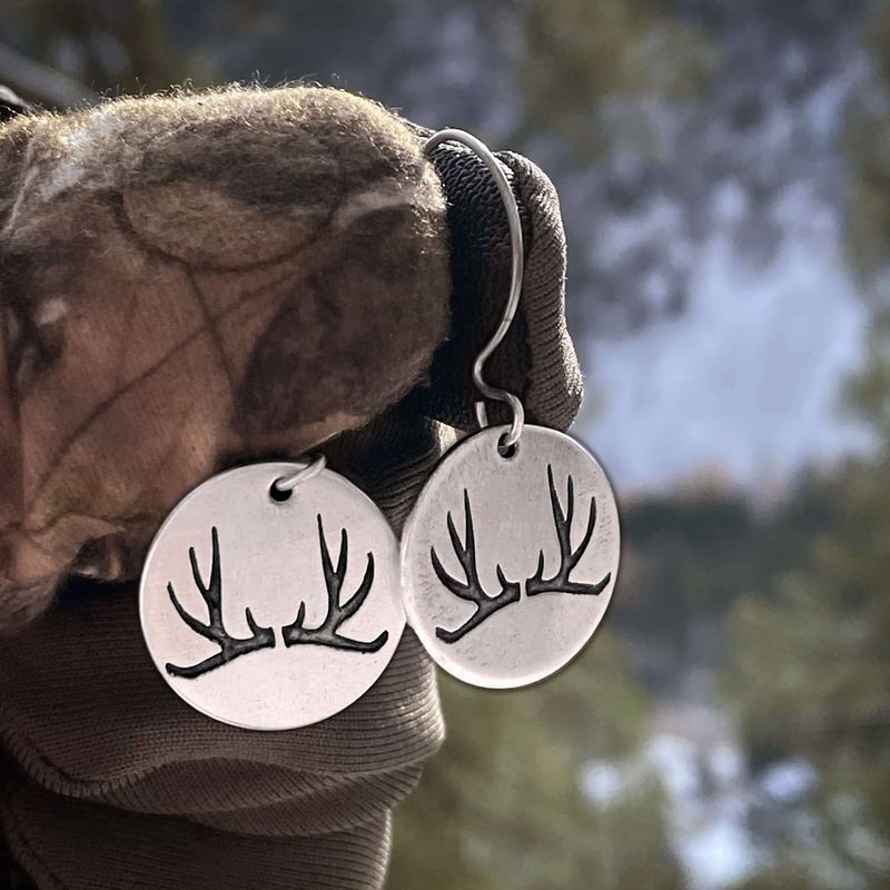 Antler Earrings featuring etched antlers on solid brass discs, showcasing elegance and outdoor inspiration.