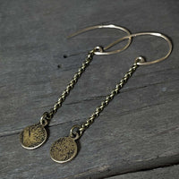 Asteroids Earrings featuring raw brass round disks with a textured design and oxidized rolo chain.