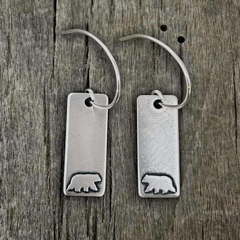 Bear Boy Earrings featuring a matte silver finish with engraved bear designs on brass rectangles.