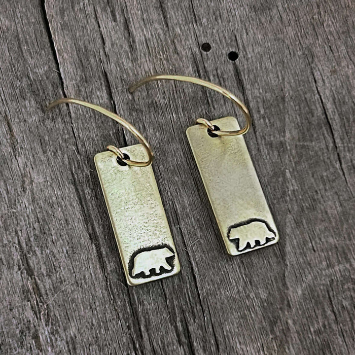 Bear Boy Earrings featuring acid-free etched bear designs on solid brass rectangles, available in Matte Silver and Antique Brass.