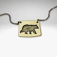 Bear Boy Necklace featuring a black bear design on a unique asymmetrical pendant.