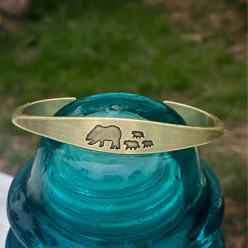 Bear Family Cuff Bracelet featuring mama bear and three cubs design on antique brass cuff against clear turquoise background
