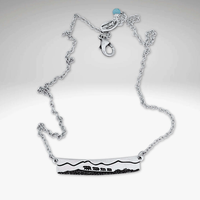 Bear Family Necklace featuring a mama bear and cubs set against mountain design in matte silver finish.