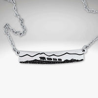 Bear Family Necklace featuring a hand-drawn design of a mama bear and cubs on a matte silver bar.