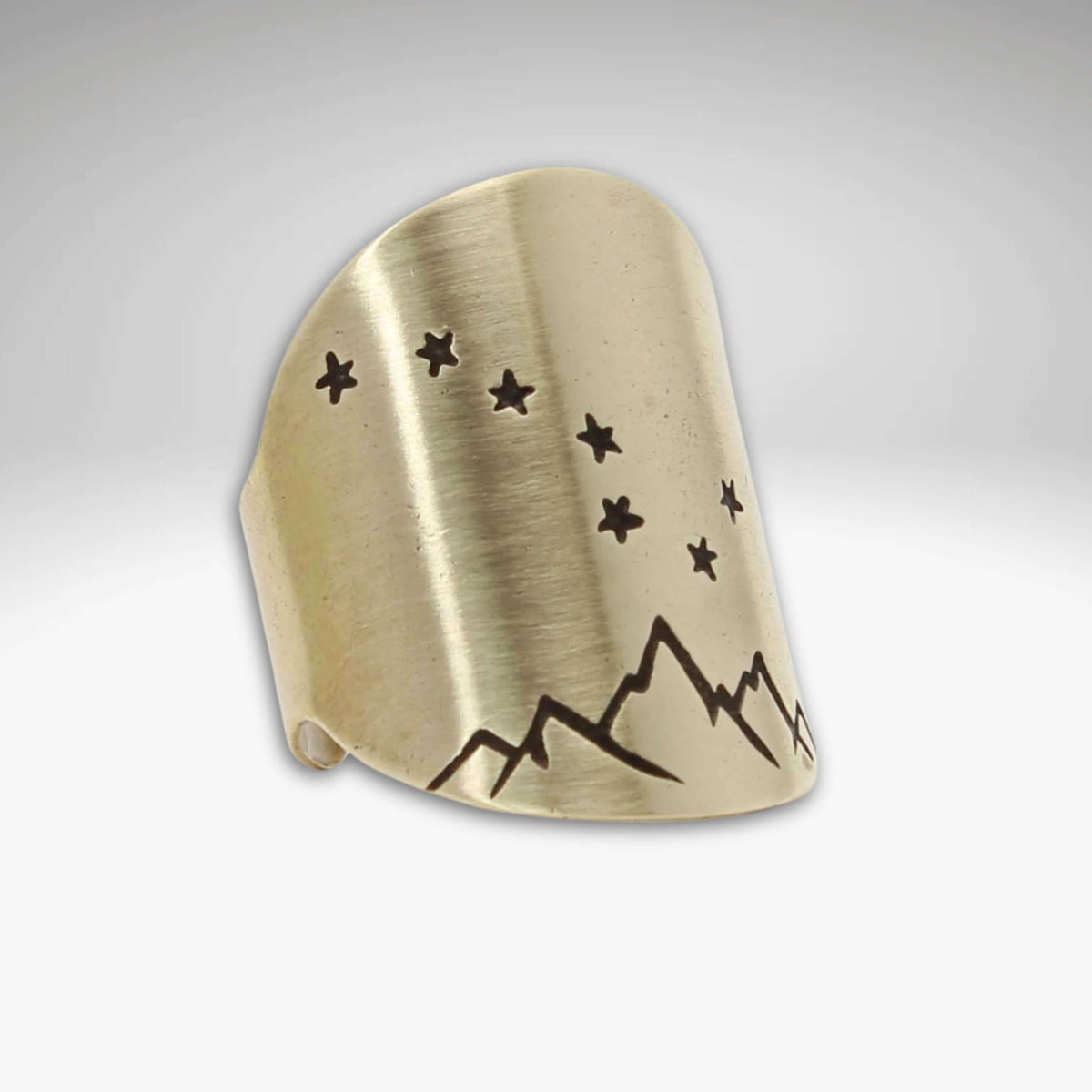 Big Dipper Adjustable Ring showcasing a brass design with mountains and stars, perfect for star-gazing enthusiasts.