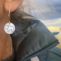 Close-up of Billy Goat Earrings worn by a woman, showcasing unique goat design and tiny star detail.