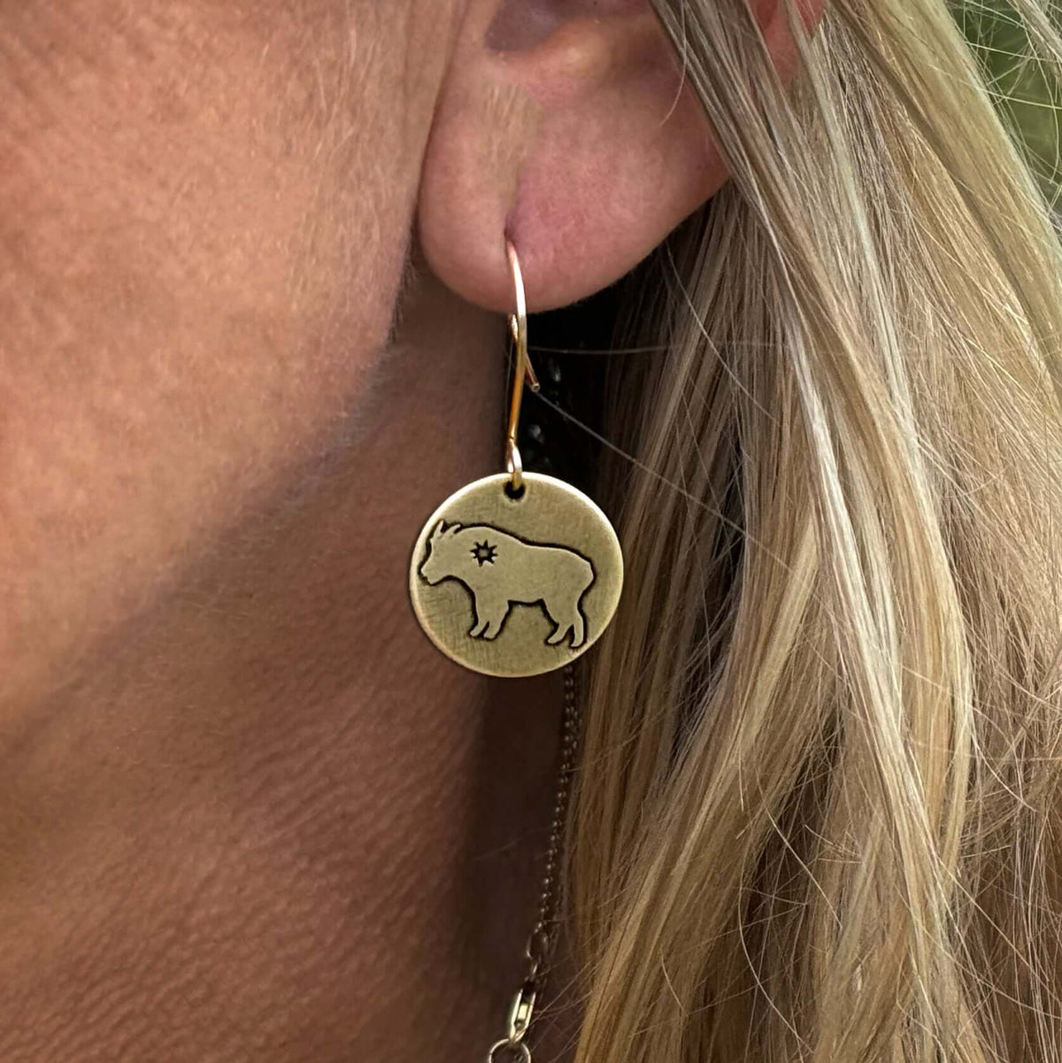 Billy Goat Earrings featuring a goat design and a tiny star, hanging from a rounded earwire.