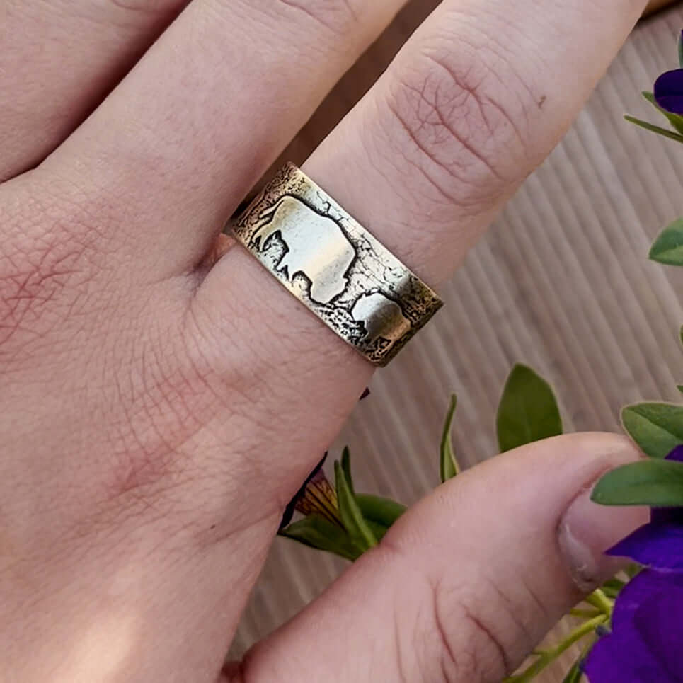 Bison Circles Adjustable Ring on a finger, showcasing the intricate bison motif design in Antique Brass.