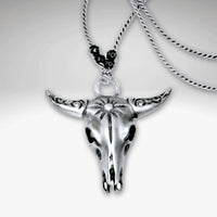 Bison Skull Necklace in matte silver finish with intricate detailing, hanging on a silk cord with hematite beads.