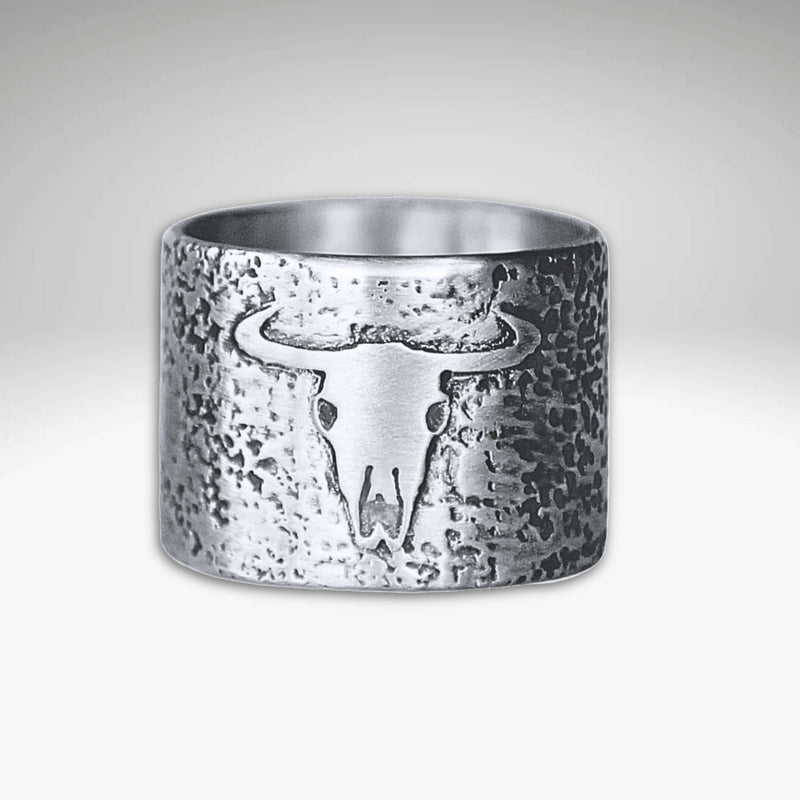 Bison Skull Ring featuring a unique bison skull design on a textured brass background.