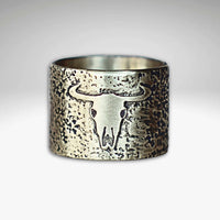 Bison Skull Ring featuring unique textured background and etched bison skull design on raw brass.