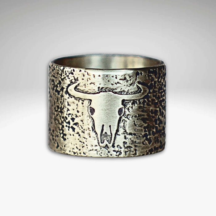 Bison Skull Ring featuring unique textured background and etched bison skull design on raw brass.
