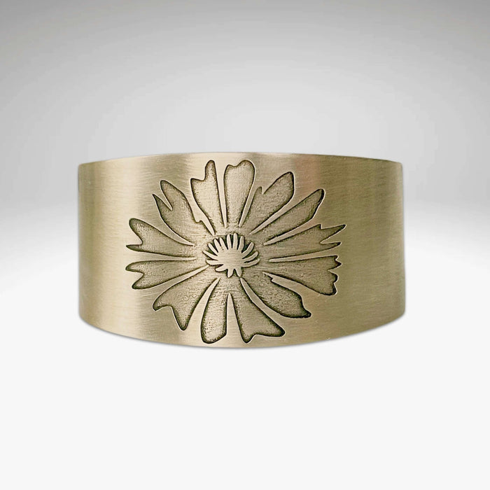 Bitterroot Flower Cuff Bracelet in antique brass finish featuring a floral design, handmade in Montana.