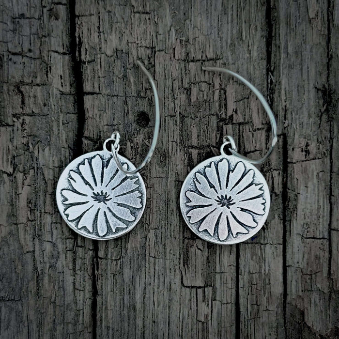 Bitterroot Flower Earrings in Matte Silver finish, featuring a detailed floral design on circular disks.