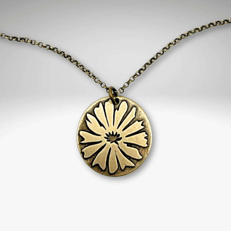 Bitterroot Necklace featuring a bold etching of the bitterroot flower on antique brass pendant.