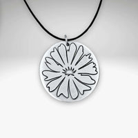 Bitterroot Necklace with fine line etching of a large bitterroot flower on a black cord.