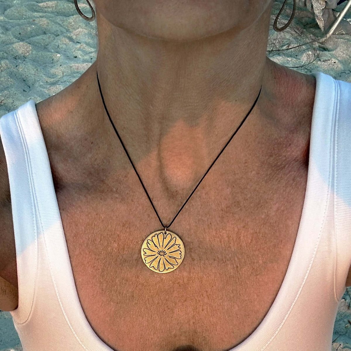 Bitterroot Necklace worn with a flowing top, featuring a bold and dainty pendant design.