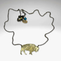 Buffalo Necklace featuring a rustic brass buffalo pendant on a cable chain, highlighting its adjustable length.