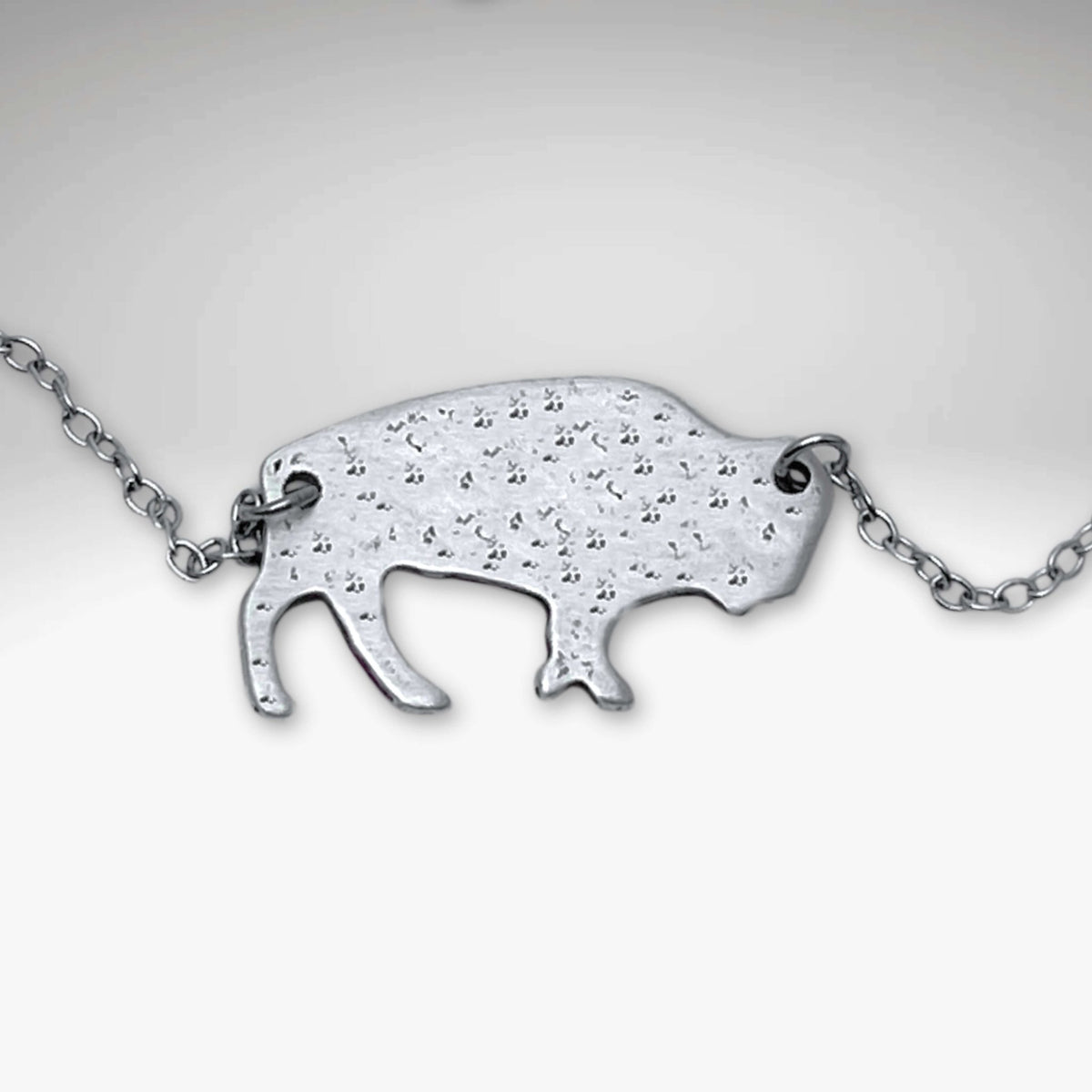 Buffalo Necklace featuring a hand-finished matte silver buffalo pendant on an 18" cable chain.