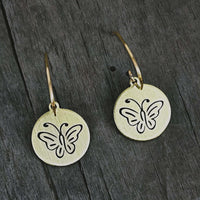 Butterfly Earrings featuring intricately etched butterflies on round metal discs in antique brass finish.