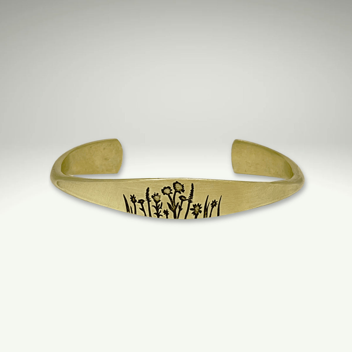 a gold bracelet with writing on it