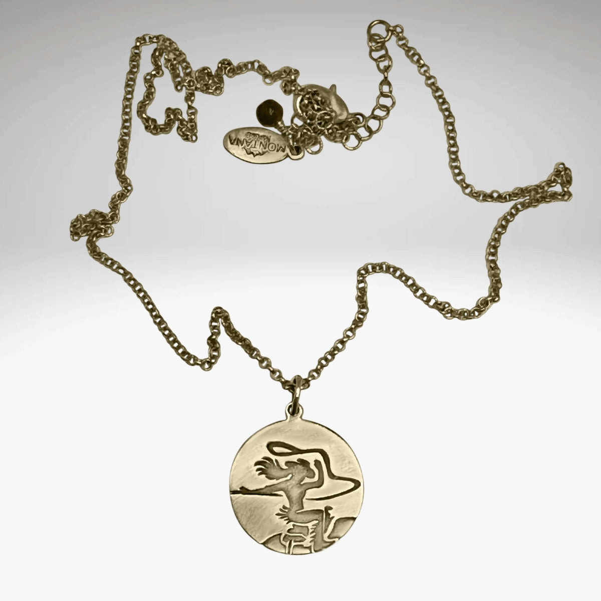 Cowgirl Necklace featuring an ornate pendant of a cowgirl riding a horse on a gold chain.