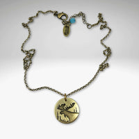Creek Moose Necklace in antique brass on rolo chain, featuring a 0.75" pendant, handmade in Montana.