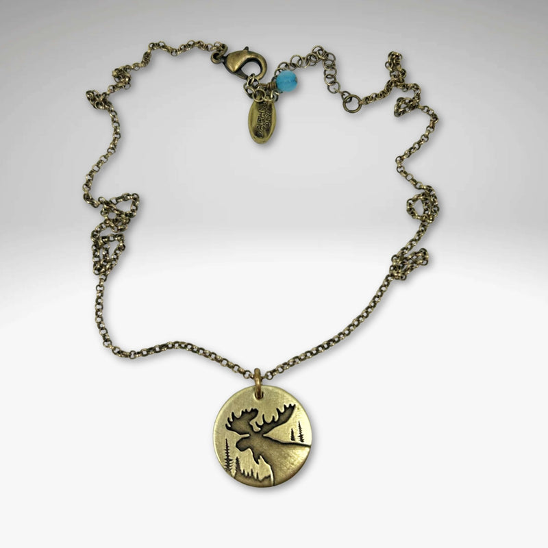 Creek Moose Necklace in antique brass on rolo chain, featuring a 0.75" pendant, handmade in Montana.