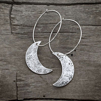 Crescent Moon Hoop Earrings featuring hammered solid brass moons and sterling silver hoops, 1 inch diameter.
