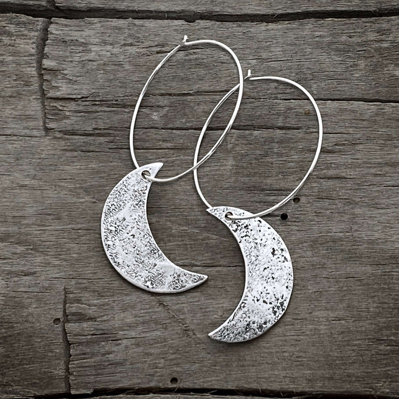 Crescent Moon Hoop Earrings featuring hammered solid brass moons and sterling silver hoops, 1 inch diameter.