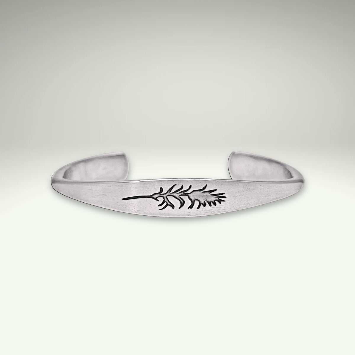 a silver bracelet with a leaf design on it