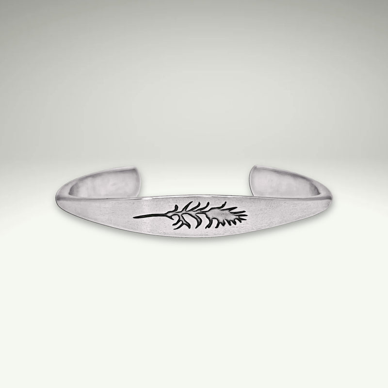 a silver bracelet with a leaf design on it