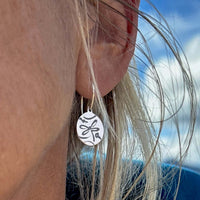 Close-up of Dragonfly Earrings in sterling silver on an ear, showcasing intricate detailing and natural aesthetics.