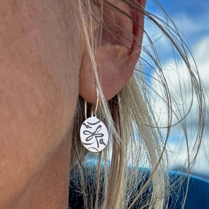 Handcrafted Dragonfly Earrings in matte silver finish on a women's earring