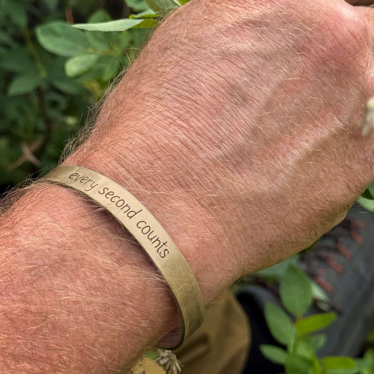 Every second counts - Bear Cuff Bracelet worn on a wrist, made with raw brass featuring unique etching.