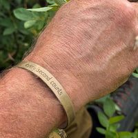 Every second counts - Bear Cuff Bracelet worn on a wrist, made with raw brass featuring unique etching.