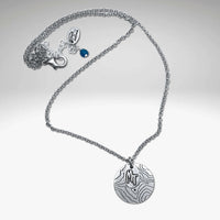 Explore MT Necklace featuring a topographic map design and MT etched on a round disk in Matte Silver.